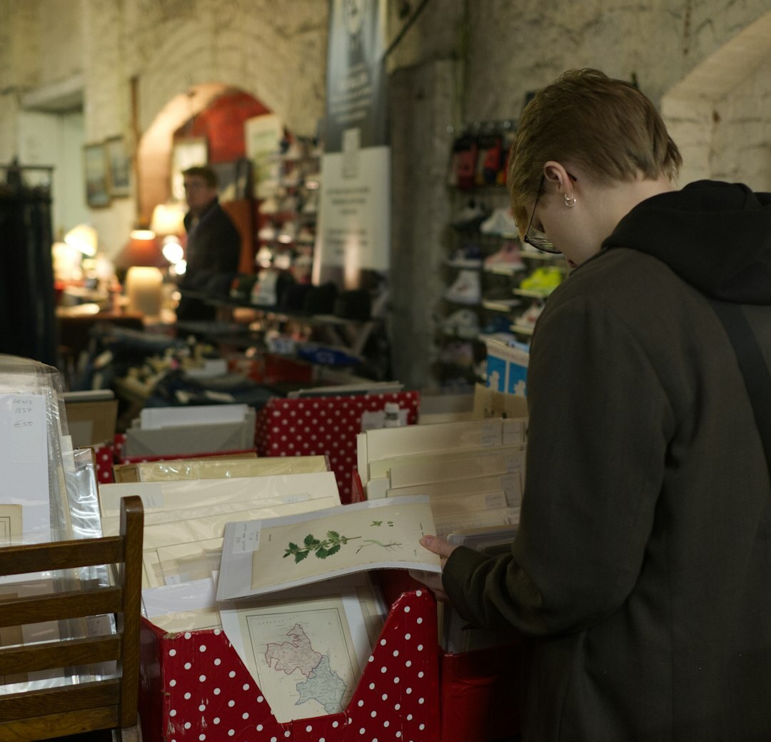 Belgian man reading a printed market report at his desk
